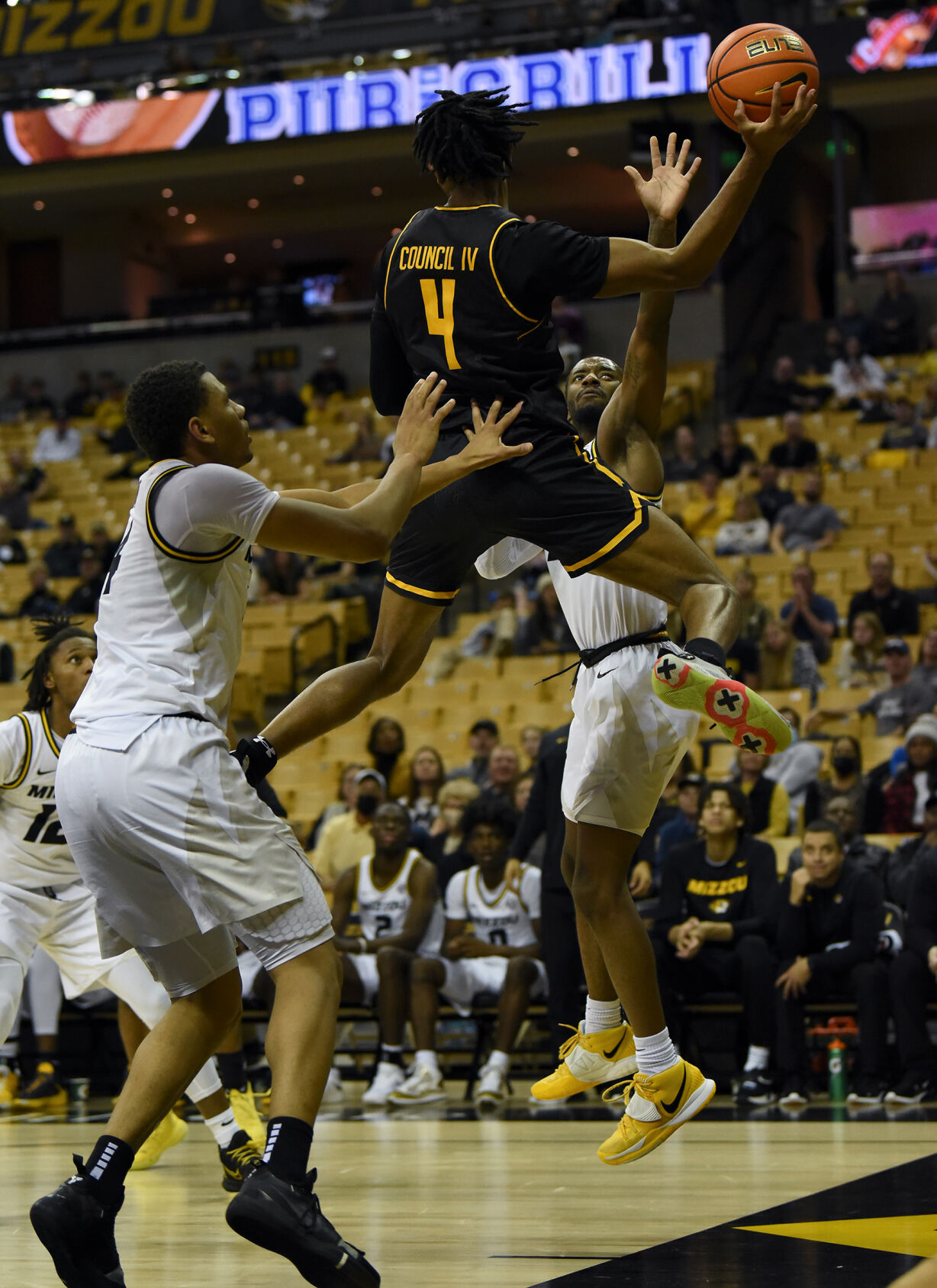 Wichita State guard Ricky Council IV attempts to send the ball down the court while Missouri's Javon Pickett, left, and Amari Davis attempt to block him
